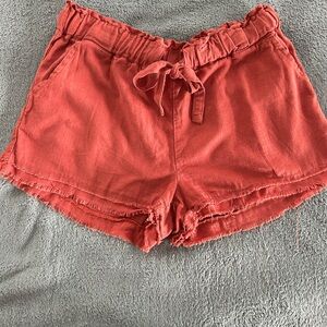 Rewash rust colored elastic tie waist shorts. Size L.